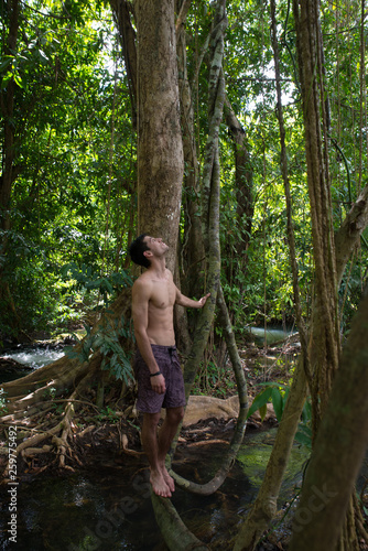 One young man relaxing in the calm of nature  tropical forest beauty. Serenity and green concepts