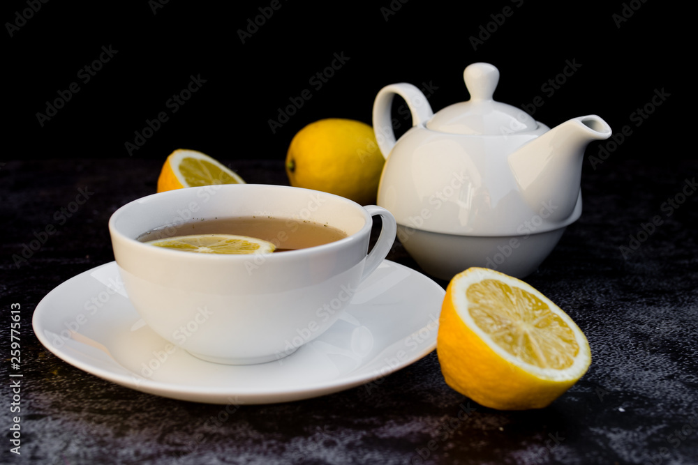 Teapot and cup of tea with fresh lemon. Teapot and cup of tea with fresh lemon.