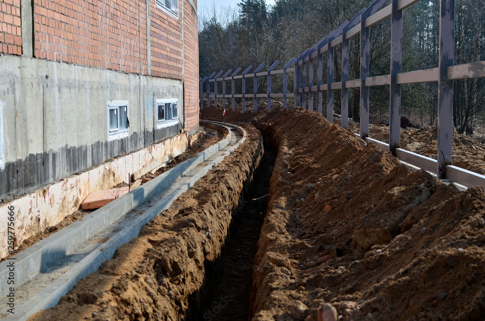 Construction site, dug trench in the ground, for pipe laying, water supply and communication, installation of a fence Construction site, dug trench in the ground, for pipe laying, water supply and communication, installation of a fence