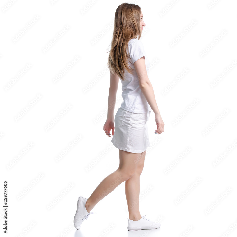 Woman in white t-shirt and skirt goes walking on white background isolation Woman in white t-shirt and skirt goes walking on white background isolation