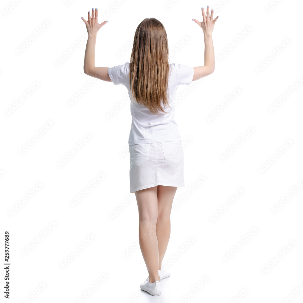 Woman in white t-shirt and skirt standing hands up on white background isolation, back view