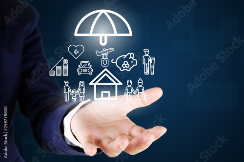 Businessman. Holding car , house , life ,healthcare , family , travel insurance icon..