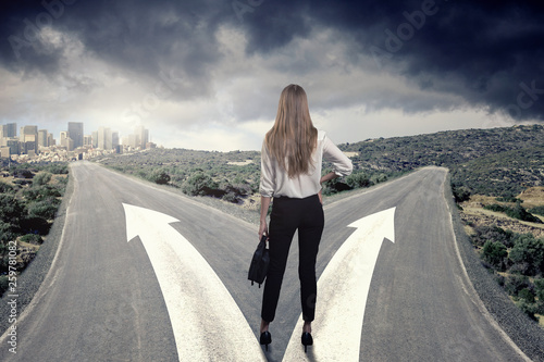 A business woman thinking which way to choose
