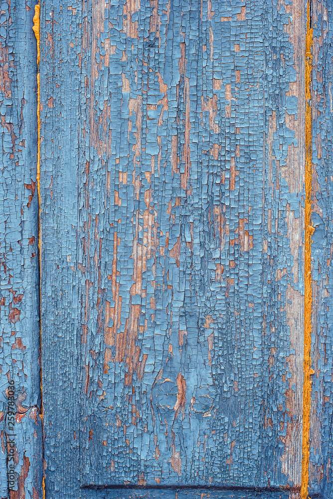 Texture of old rusty wood, painted blue with spots of first yellow layer.