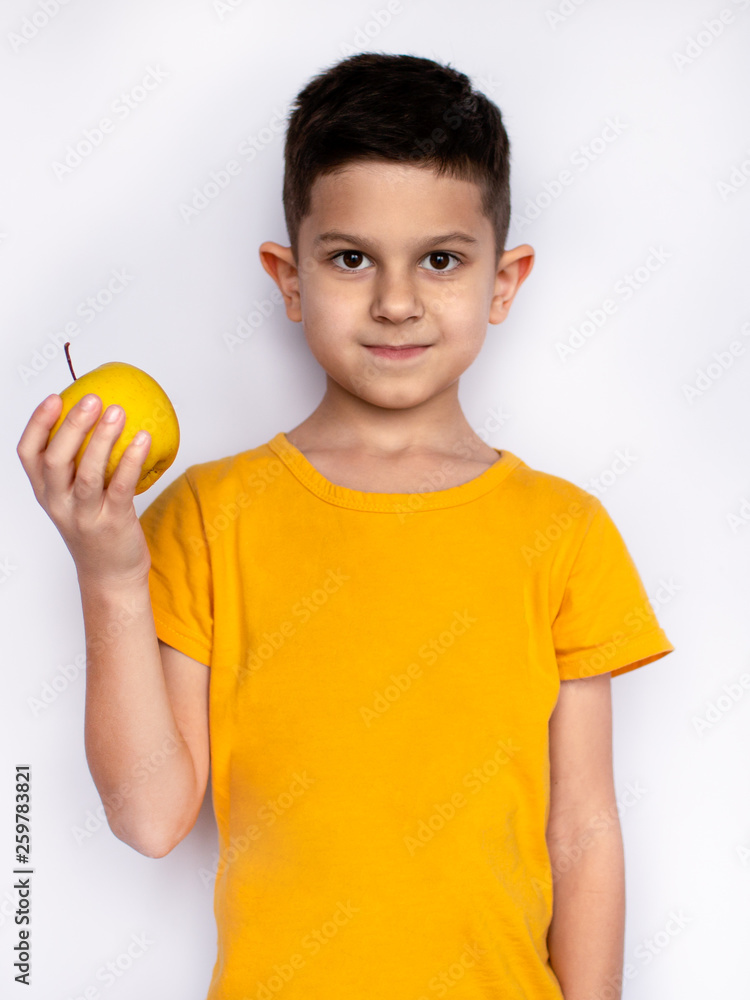 hispanic little boy with apple, isolated on white background hispanic little boy with apple, isolated on white background