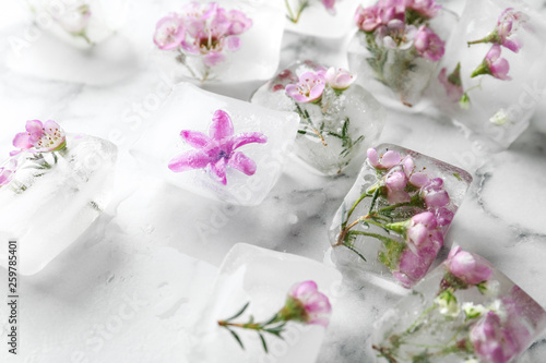 Floral ice cubes on marble table © New Africa