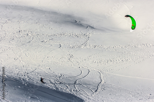 Snow kite in powder snow in Passo Giau, high alpine pass near Cortina d'Ampezzo, Dolomites, Italy photo