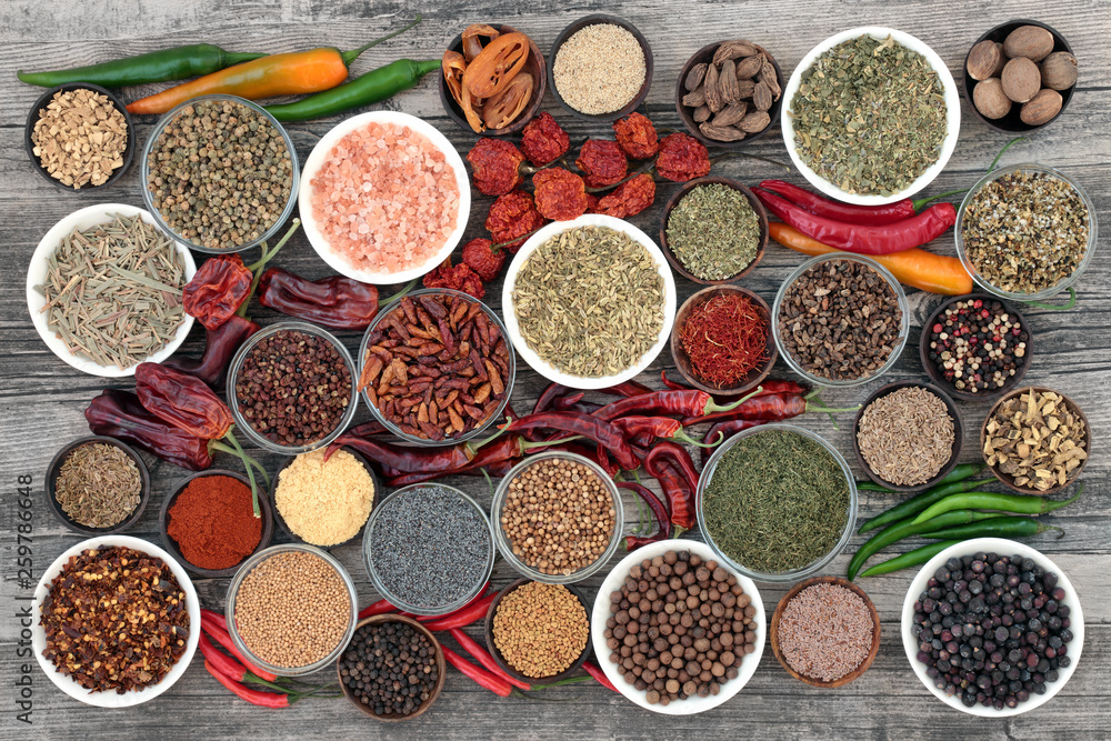 Herb and spice food selection dried and fresh on rustic wood background. With dried ring of fire, padron and scorpio chilli peppers. Top view. Herb and spice food selection dried and fresh on rustic wood background. With dried ring of fire, padron and scorpio chilli peppers. Top view.