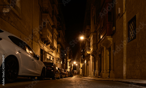 Valletta, MALTA-may 1:Valletta on night time, MALTA in may 1,2018. Valletta by night.Typical street leading to the sea in Valletta,Malta at night. Buildings with traditional colorful maltese balconies