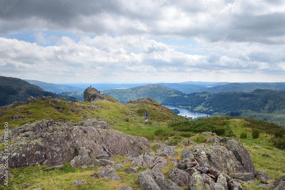 Walker on the summit of Helm Crag Walker on the summit of Helm Crag