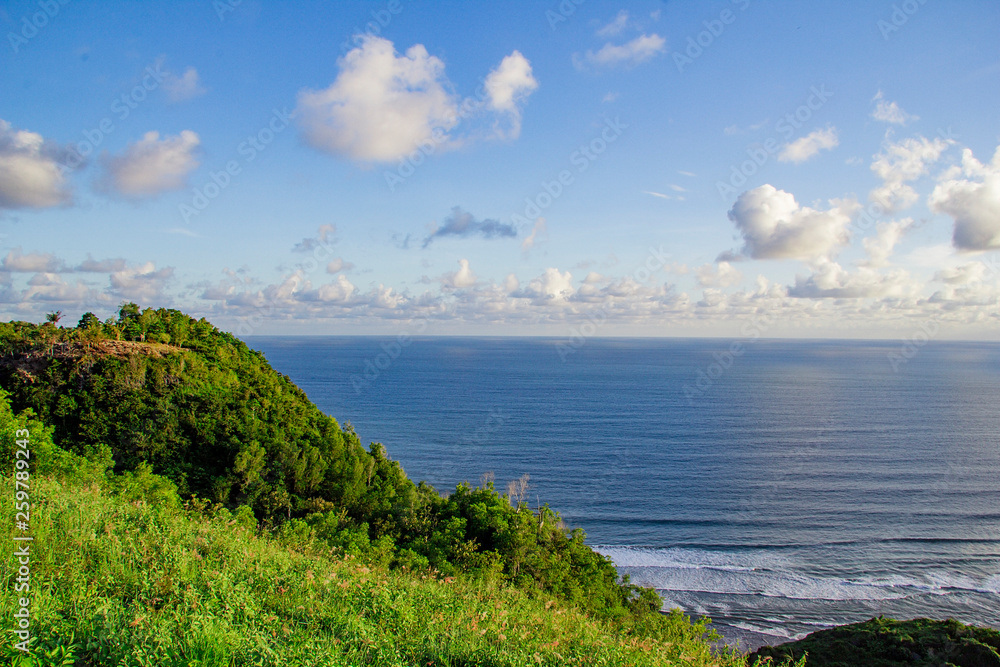 paragliding hill watugupit at yogyakarta, beautiful view of hill and sea with blue sky and clouds paragliding hill watugupit at yogyakarta, beautiful view of hill and sea with blue sky and clouds