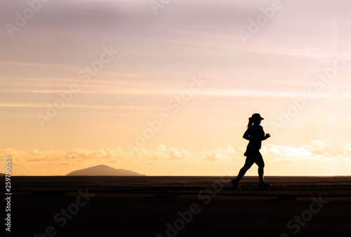 Woman Running on the Beach at Sunset