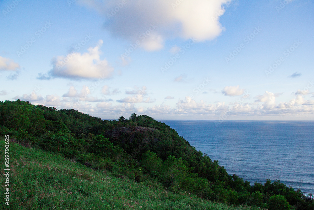 paragliding hill watugupit at yogyakarta, beautiful view of hill and sea with blue sky and clouds