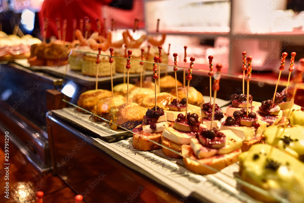 Tapas on Crusty Bread - Selection of Spanish tapas served on a sliced baguette.