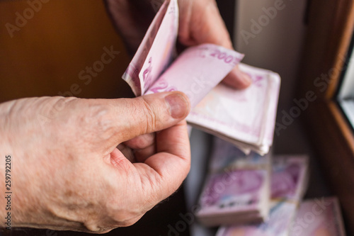 man counting 200 turkish lira banknote