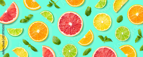 Colorful pattern of citrus fruit slices and mint leaves