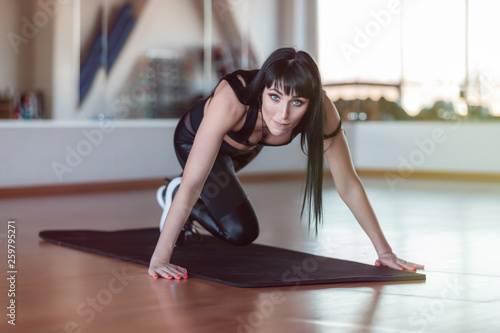 Fitness sportswoman in fashion sportswear doing fitness exercise in the gym