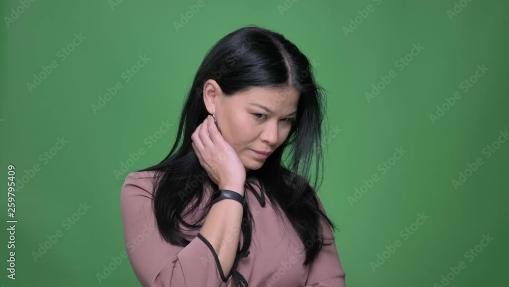 Closeup shoot of young attractive asian female being thoughtful and fixing her hair in front of the camera Closeup shoot of young attractive asian female being thoughtful and fixing her hair in front of the camera