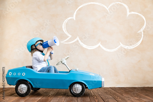 Cuadro en lienzo Funny kid driving toy car at home