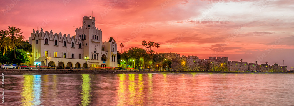 Obraz premium Wonderful Greece. Attractions of the island of Kos. Kos fortress and the municipal building at sunset, Kos town, Kos island, Dodecanese, Greece