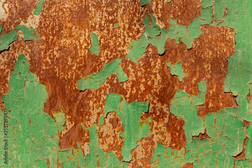 Corrosion of metal. Peeling green paint from the iron surface.