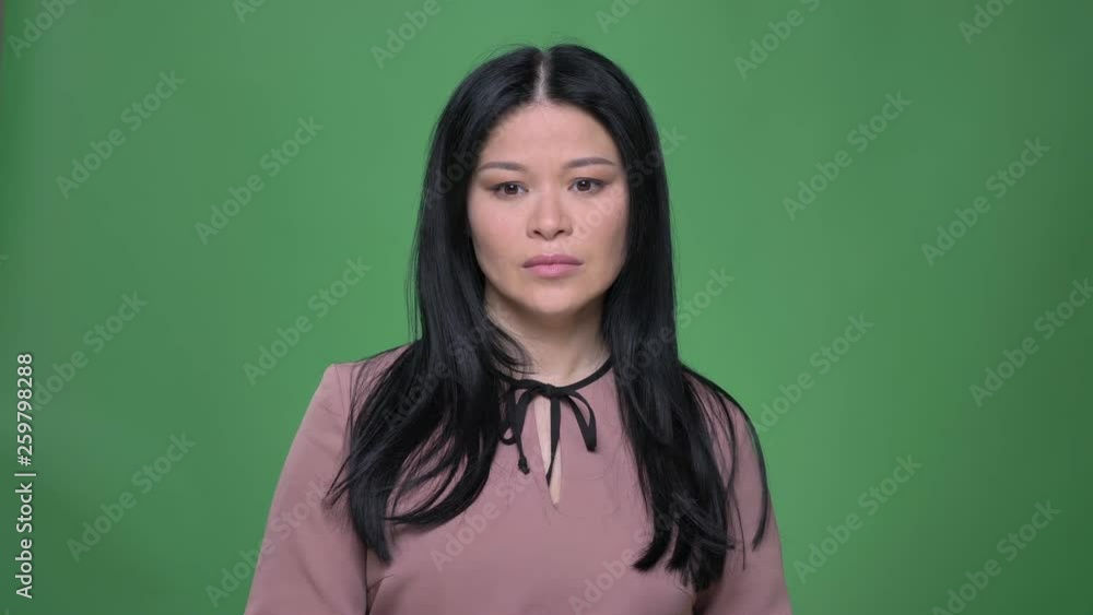 Closeup shoot of young attractive korean female being sad and depressed in front of the camera Closeup shoot of young attractive korean female being sad and depressed in front of the camera