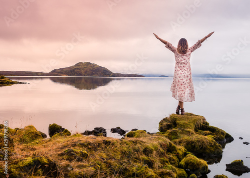 Woman standing on the shore photo