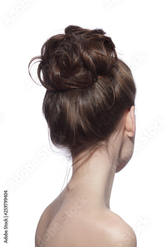 Back of young slim woman with fancy prom hair bun