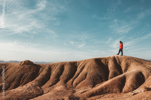 Tourist on sandy canyon hills photo