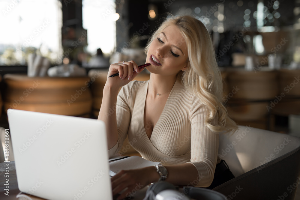 Sexy woman using laptop pc sitting in cafe Stock Photo Adobe Stock