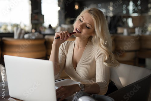 Sexy woman using laptop pc sitting in cafe