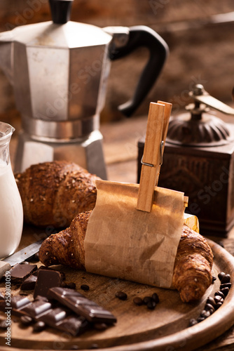 Coffee cup with a croissant and fresh coffee photo