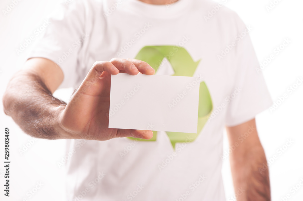 Business man holding out a card with a reycyling symbol Business man holding out a card with a reycyling symbol