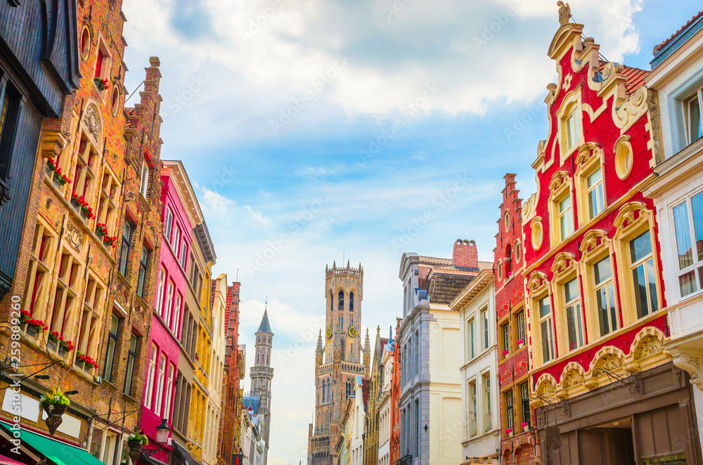 Fototapeta premium The Belfry Tower (aka Belfort) and traditional narrow streets in Bruges (Brugge), Belgium