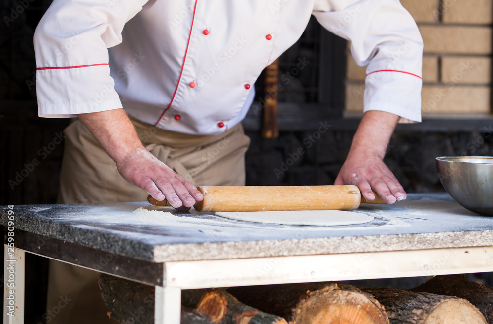 cook preparing pizza in a restaurant. cook preparing pizza in a restaurant.