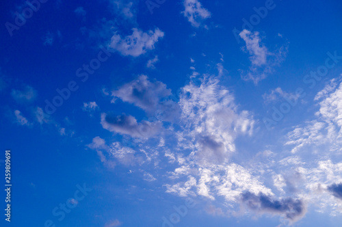 blue evening sky with white and gray clouds; cumulus. background; nature