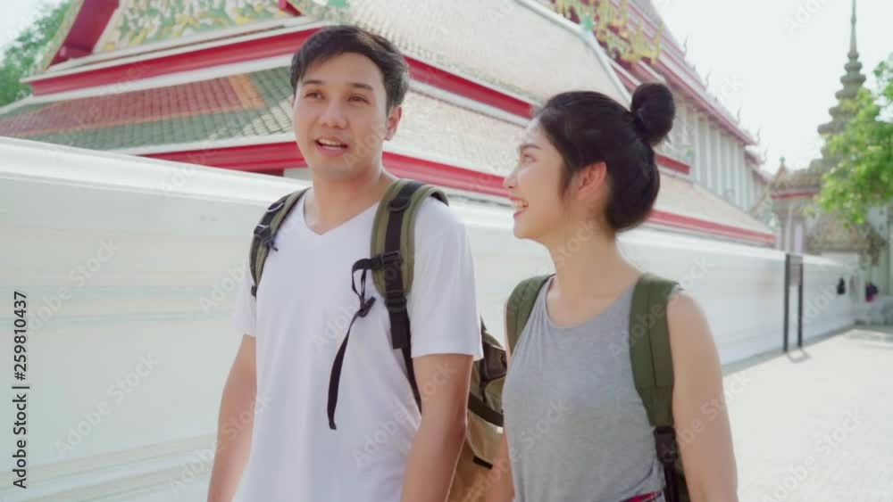 Slow motion - Traveler Asian couple traveling and walking in Bangkok, Thailand, sweet couple feeling happy spending sweet time in holiday trip. Lifestyle couple travel in city concept. Slow motion - Traveler Asian couple traveling and walking in Bangkok, Thailand, sweet couple feeling happy spending sweet time in holiday trip. Lifestyle couple travel in city concept.