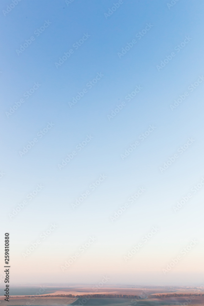 Obraz premium blue sky and fog over the field. autumn evening. landscape
