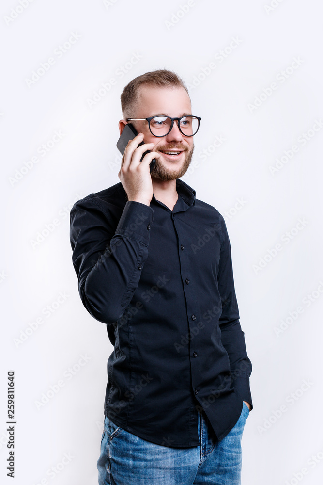 Happy smiling young man talking on mobile phone on white background Happy smiling young man talking on mobile phone on white background