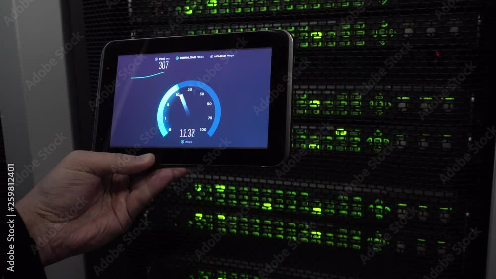 IT engineer measures network speed with a tablet computer in hand. LEDs blink. On background server racks. There is vibration in the video. Concept 3.0 IT engineer measures network speed with a tablet computer in hand. LEDs blink. On background server racks. There is vibration in the video. Concept 3.0