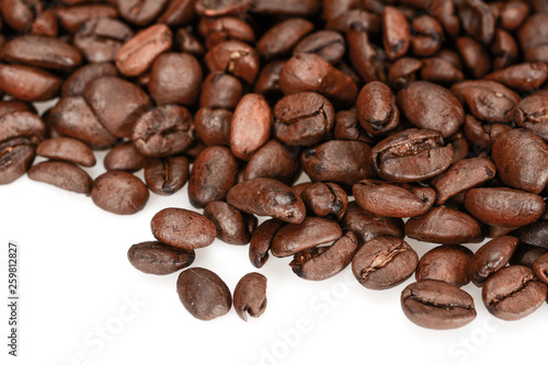 Roasted coffee beans  dark brown close up isolated on a white background