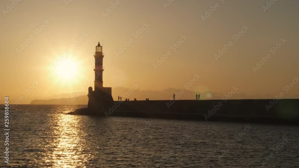 Sunset over The Venetian era harbour and lighthouse at the Mediterranean port of Chania, Crete Sunset over The Venetian era harbour and lighthouse at the Mediterranean port of Chania, Crete
