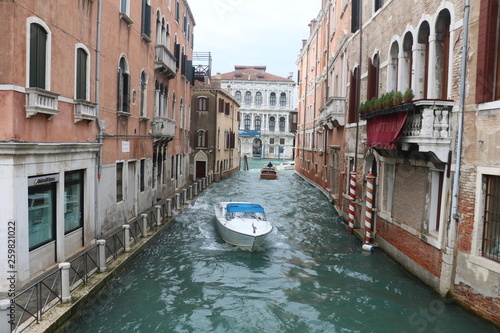 Boat floating down Venice Canal