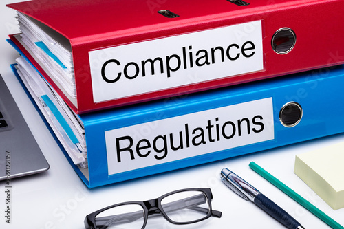 Compliance And Regulation Folder On Office Desk photo