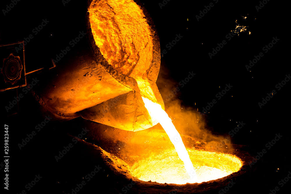 metal casting process with red high temperature fire in metal part ...