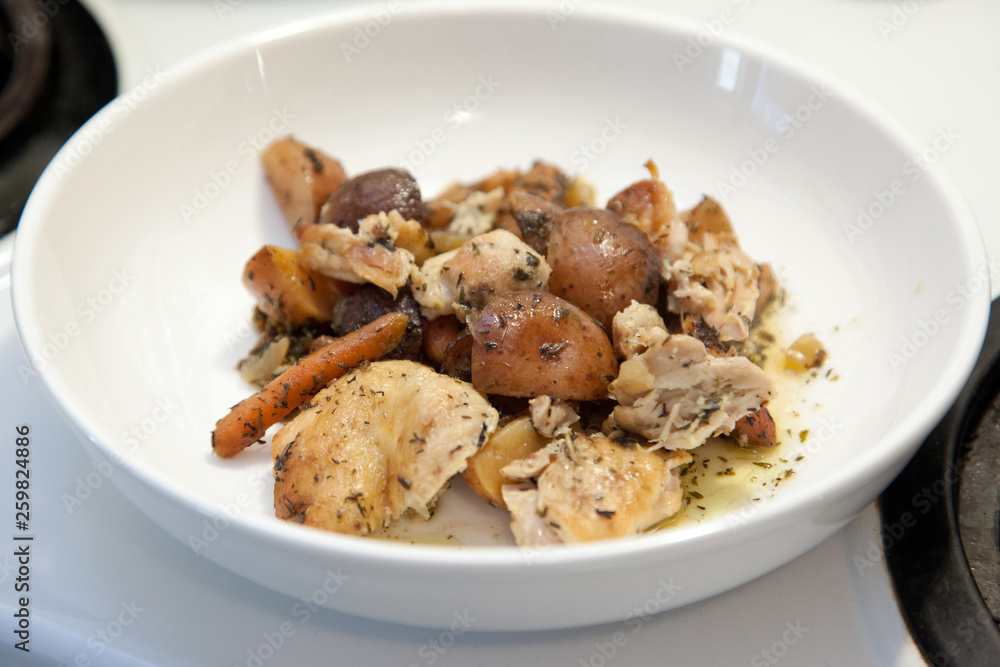 White bowl with fresh chicken stew with potato and carrot White bowl with fresh chicken stew with potato and carrot