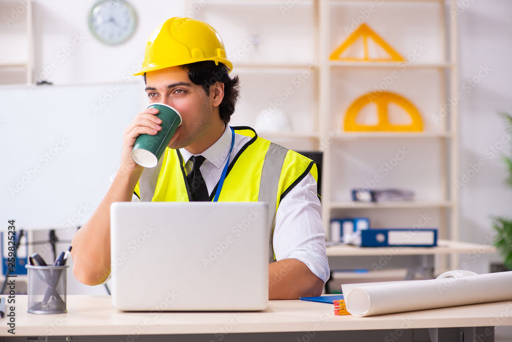 Male construction engineer working in the office Male construction engineer working in the office