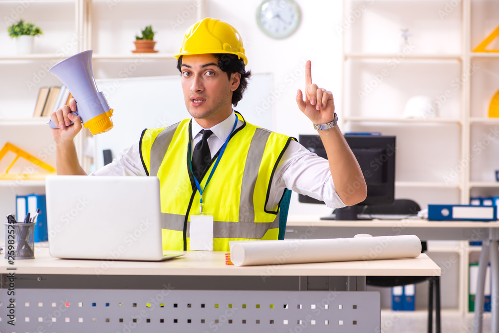 Male construction engineer working in the office Male construction engineer working in the office