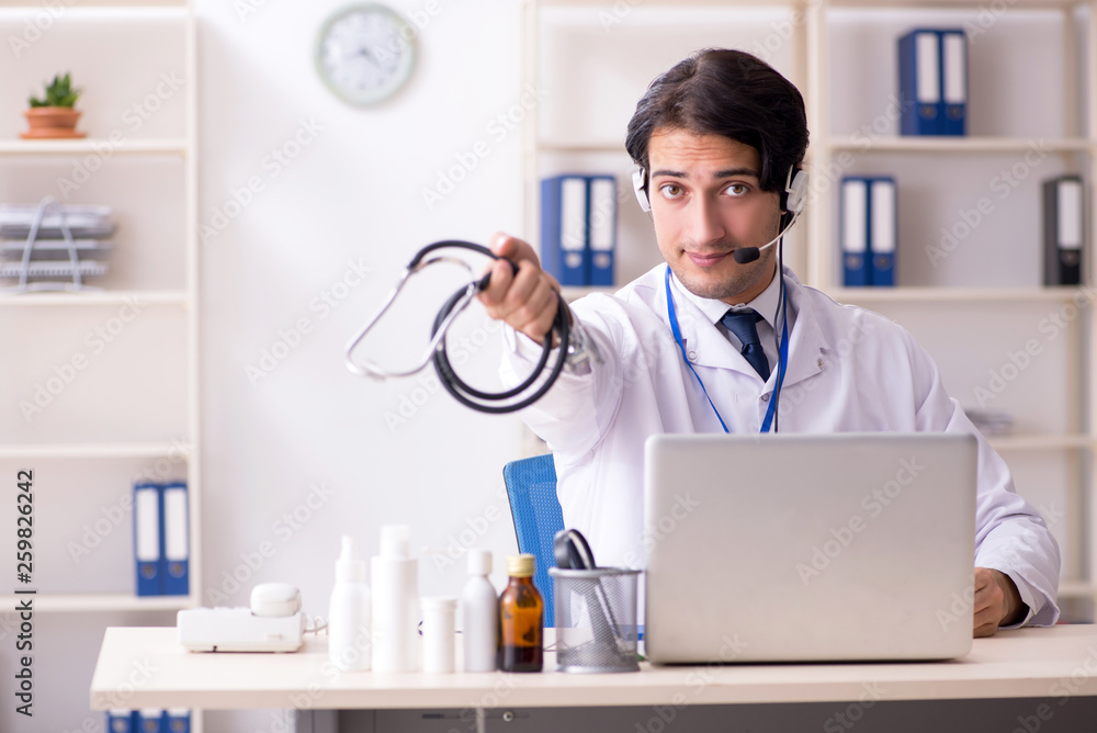 Young male doctor in telemedicine concept Young male doctor in telemedicine concept