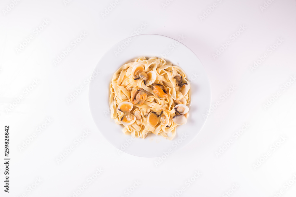noodle dish with mussels and clams on white background noodle dish with mussels and clams on white background